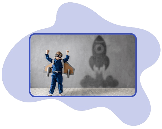 Child in a pilot cap and cardboard wings with arms raised; their shadow on the wall is shaped like a rocket taking off, in a rounded photo on a soft purple shape.